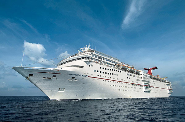 Carnival Cruise Lines’ 855-foot-long Carnival Ecstasy cruises off Cozumel, Mexico. The 70,000-ton, 2,052-passenger liner is part of the line’s popular Fantasy-class, one of the most successful series of cruise ships ever introduced. Photo by Andy Newman/Carnival Cruise Lines.